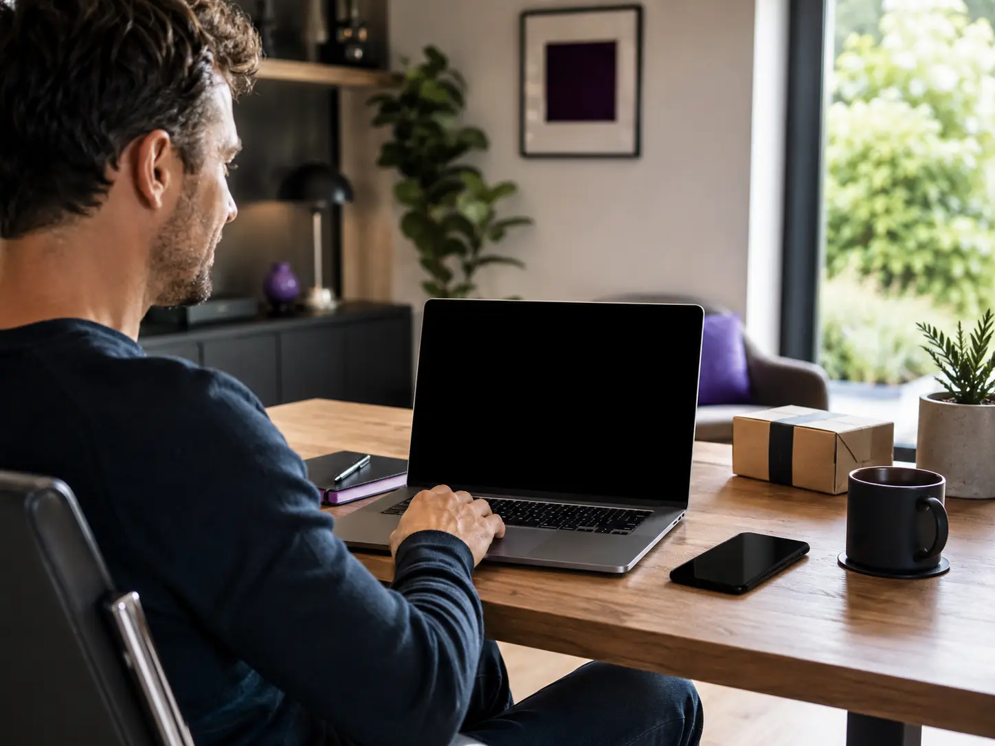 Customer support workspace with a laptop, phone and parcel on a desk.